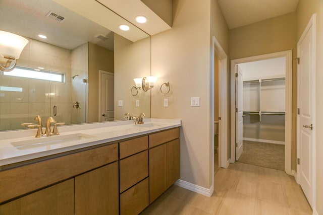 bathroom with an enclosed shower, vanity, and toilet