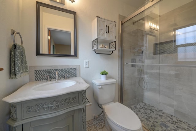 bathroom featuring tasteful backsplash, vanity, an enclosed shower, and toilet