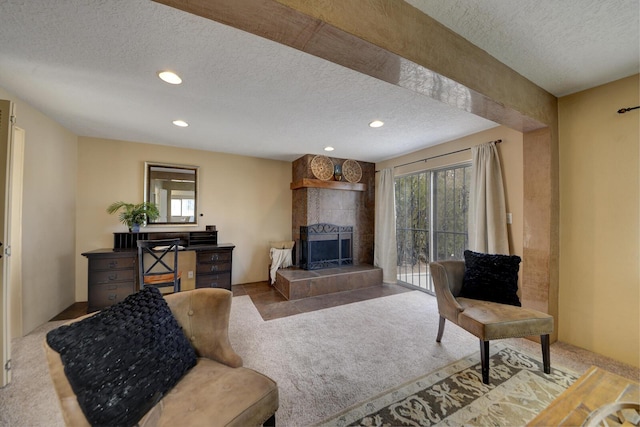 carpeted living room featuring a fireplace and a textured ceiling