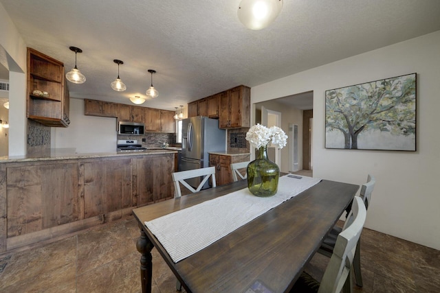 dining space featuring a textured ceiling