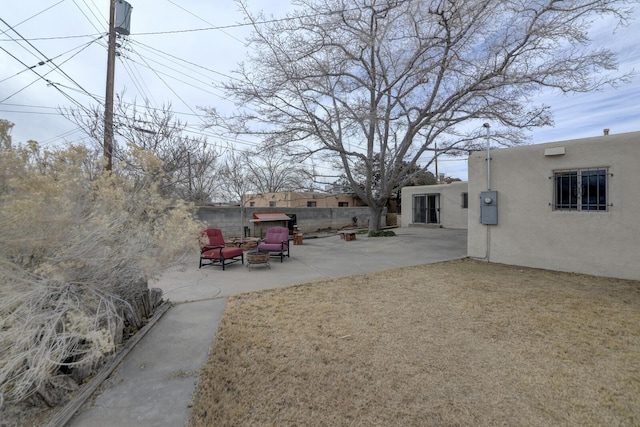 view of yard with an outdoor fire pit and a patio area