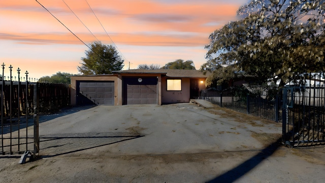 view of garage at dusk