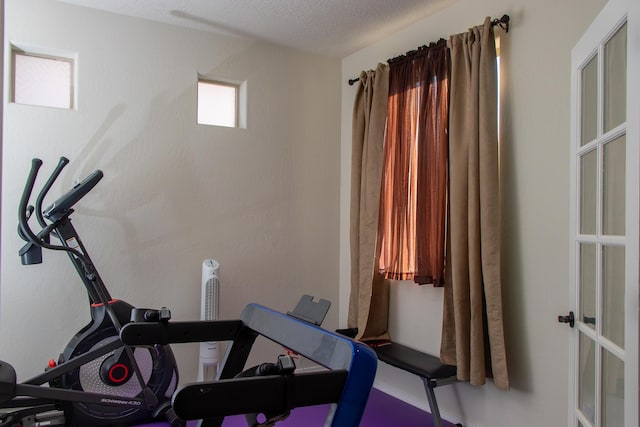 exercise area featuring a textured ceiling