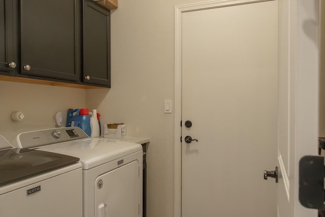 clothes washing area with cabinets and independent washer and dryer