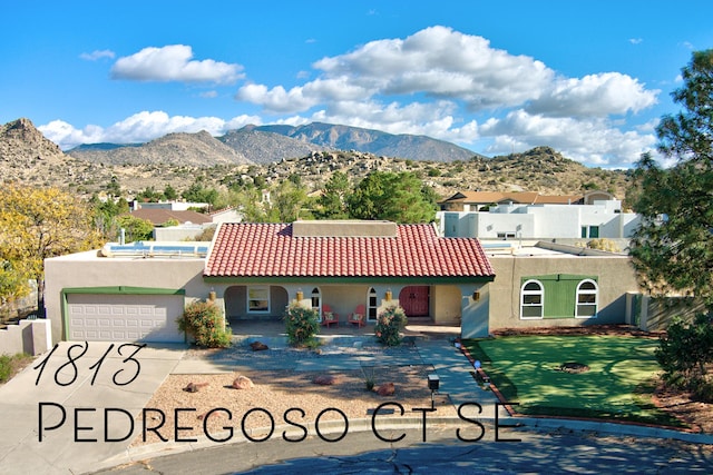 view of front of property with a tile roof, a mountain view, and stucco siding