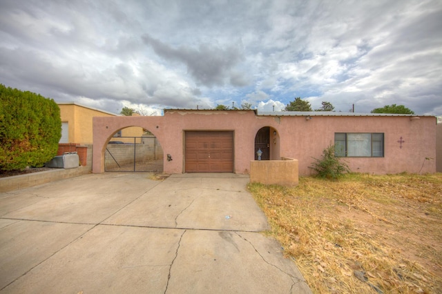 pueblo-style house with a garage