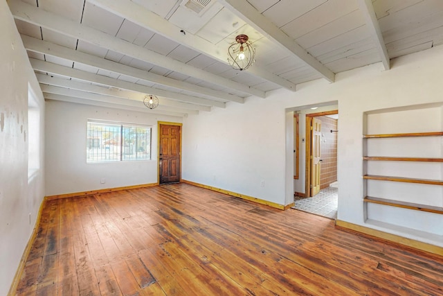 empty room featuring wood ceiling, hardwood / wood-style flooring, and beam ceiling