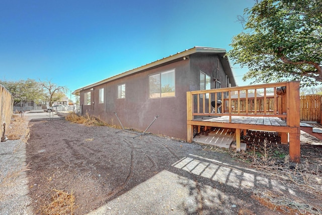 view of side of home with a deck