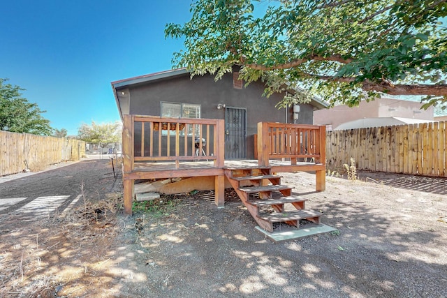 rear view of house with a wooden deck