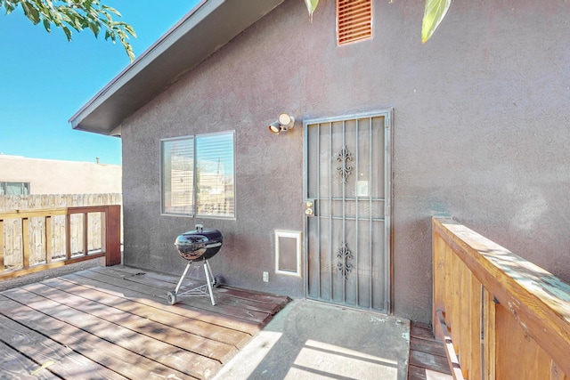 view of exterior entry with a wooden deck