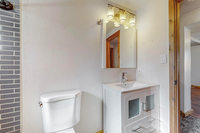 bathroom with hardwood / wood-style flooring, vanity, and toilet