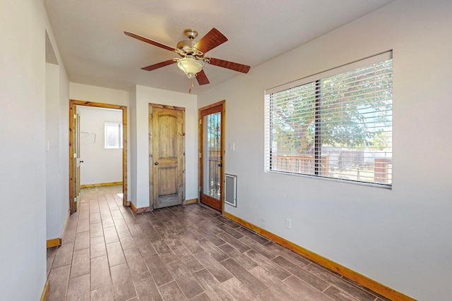 interior space with dark hardwood / wood-style flooring and ceiling fan