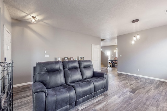 living room featuring hardwood / wood-style floors and a textured ceiling