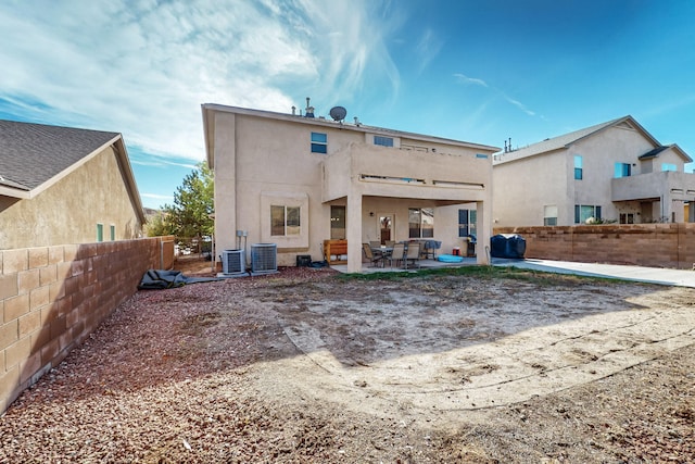 back of house featuring cooling unit and a patio area