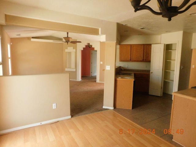 kitchen featuring sink, ceiling fan, and wood-type flooring