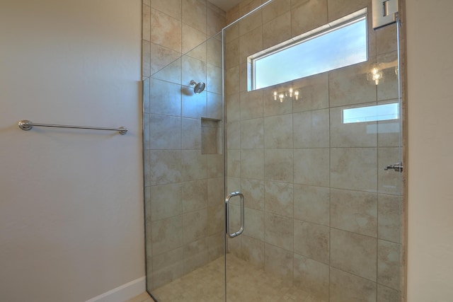 bathroom featuring a shower with shower door