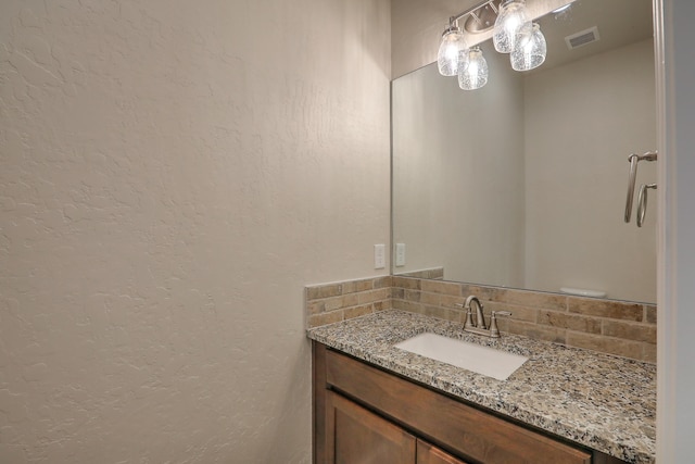 bathroom featuring backsplash and vanity