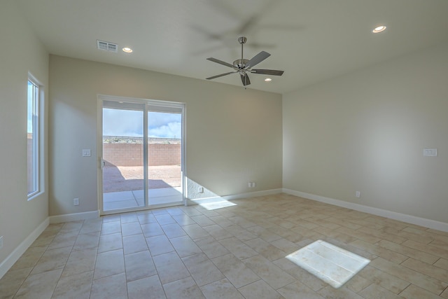 spare room with light tile patterned floors and ceiling fan