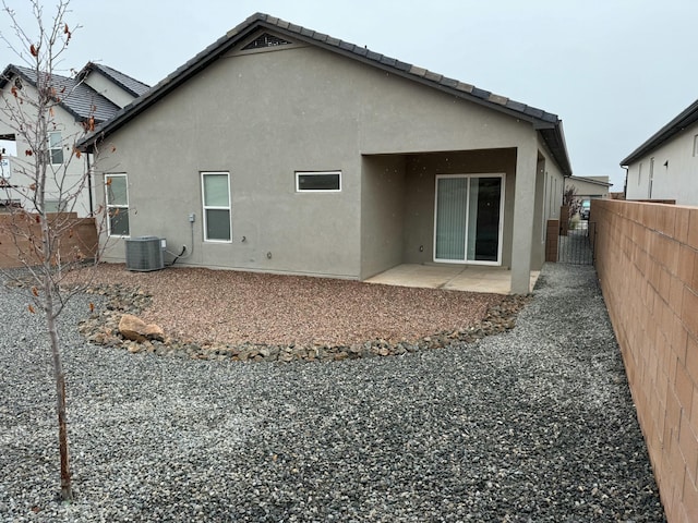 rear view of property with a patio area and cooling unit