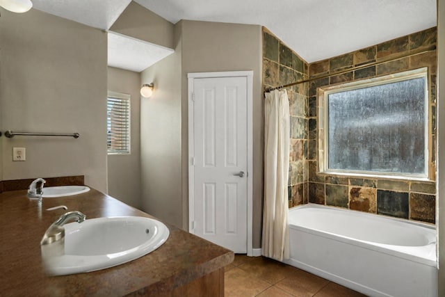 bathroom with sink, shower / bath combo, a textured ceiling, and tile patterned flooring