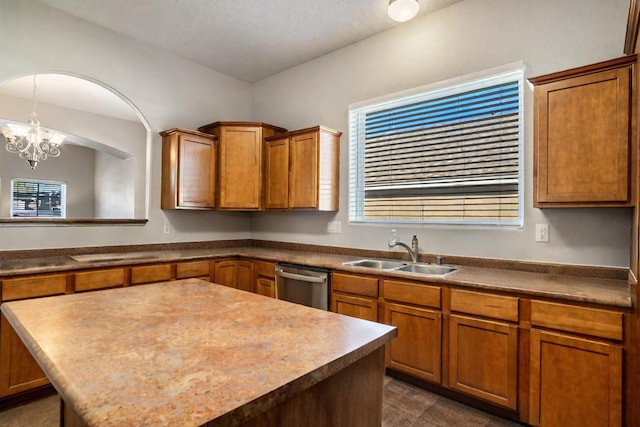 kitchen featuring dishwasher, an inviting chandelier, brown cabinets, and a sink