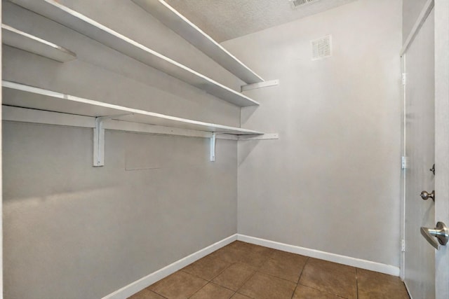 walk in closet featuring tile patterned floors and visible vents