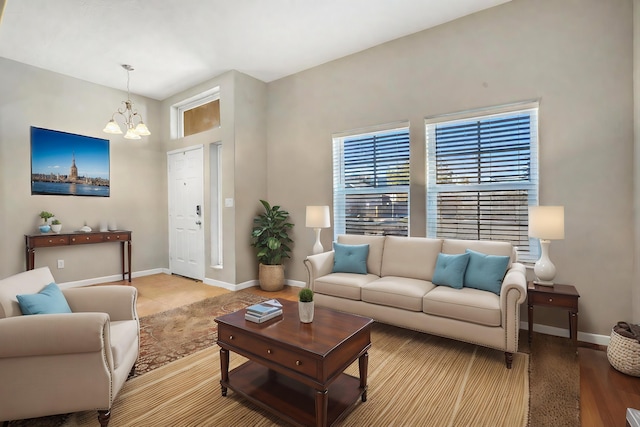 living area with a notable chandelier and baseboards