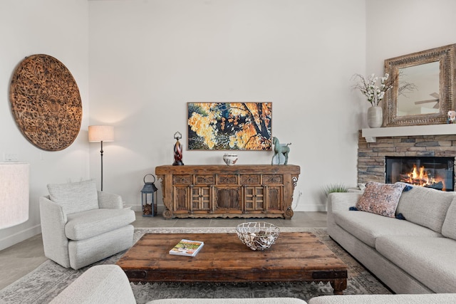 living room with a stone fireplace