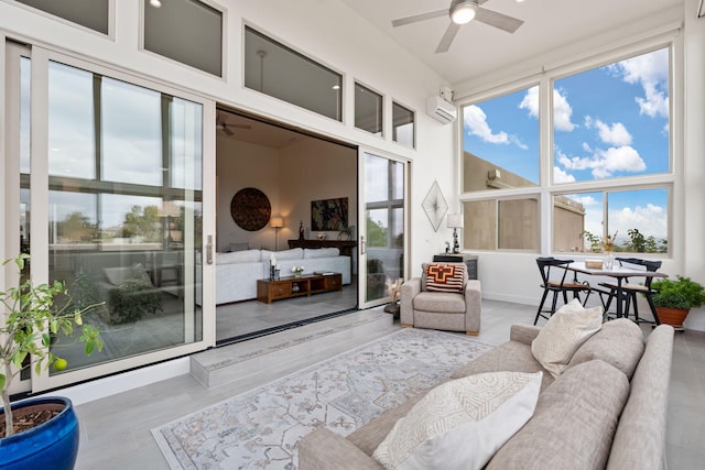 sunroom with ceiling fan, an AC wall unit, and a wealth of natural light