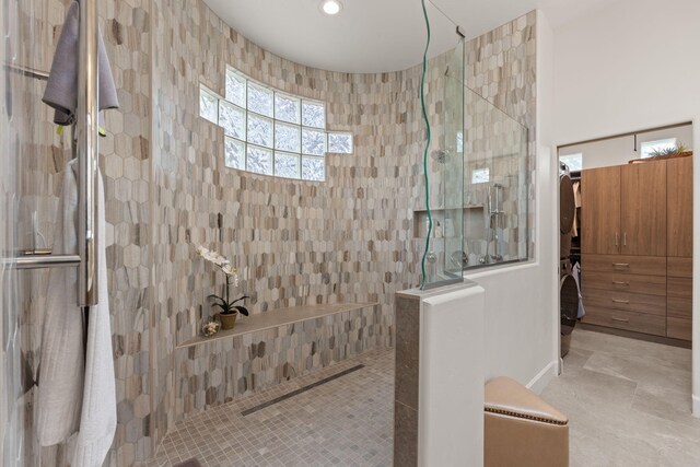 bathroom featuring tile walls and tiled shower