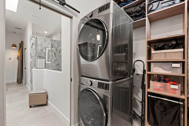 clothes washing area featuring stacked washer / drying machine