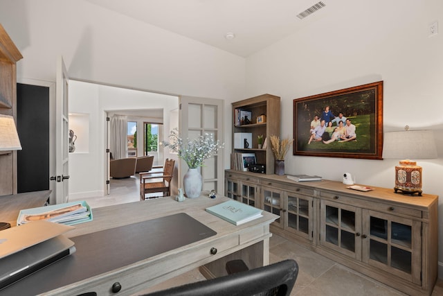 living room with lofted ceiling and light tile patterned flooring