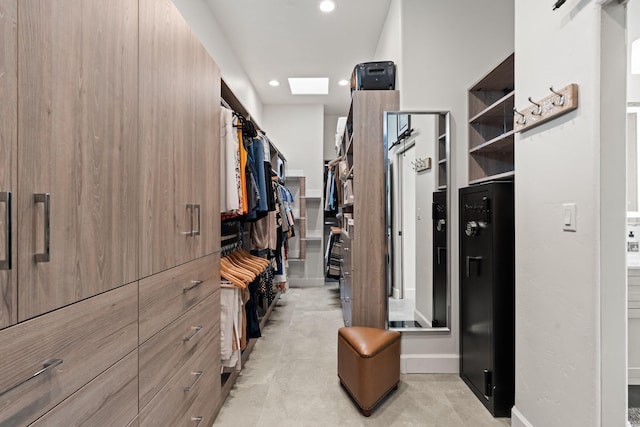 spacious closet with a skylight