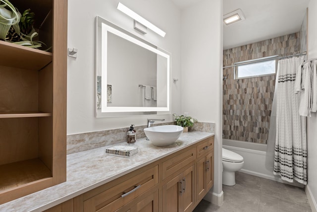 full bathroom with tile patterned flooring, shower / bath combo with shower curtain, vanity, and toilet