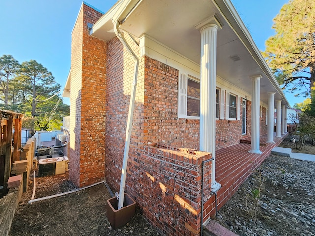 view of side of property with covered porch