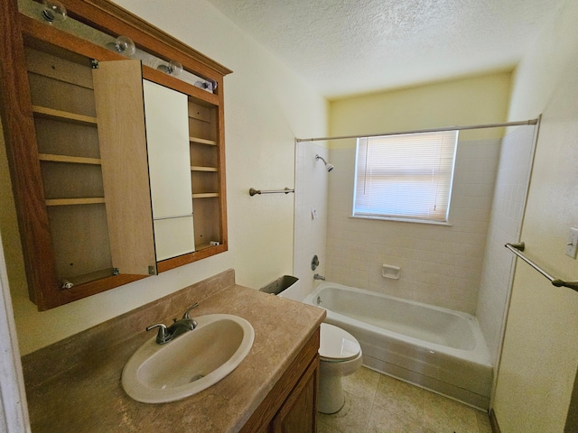 full bathroom with vanity, tile patterned floors, tiled shower / bath combo, toilet, and a textured ceiling