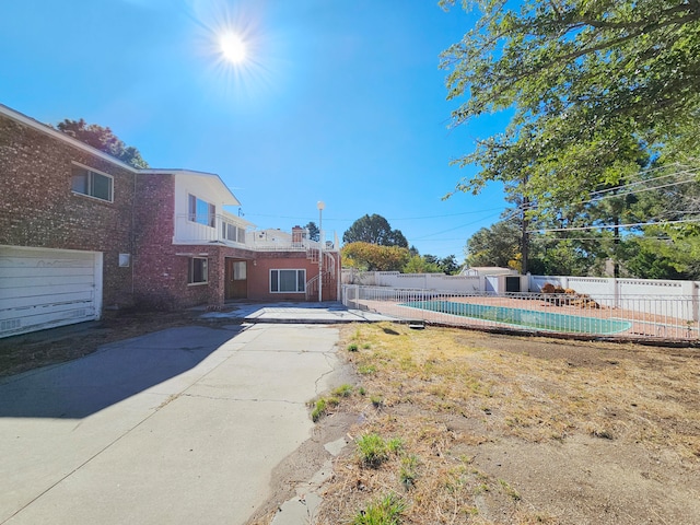 view of yard featuring a patio and a fenced in pool