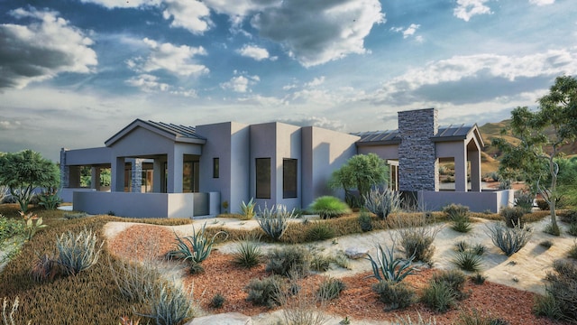 53 Evergreen Dr, Placitas, NM 87043 - modern home with stucco siding, a standing seam roof, and a metal roof
