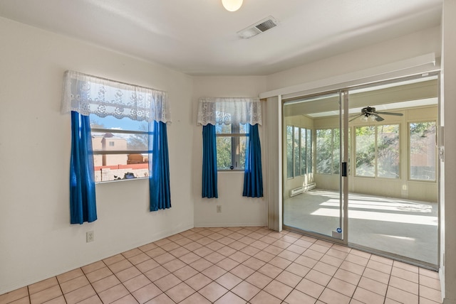 unfurnished room featuring light tile patterned flooring, a wealth of natural light, and ceiling fan