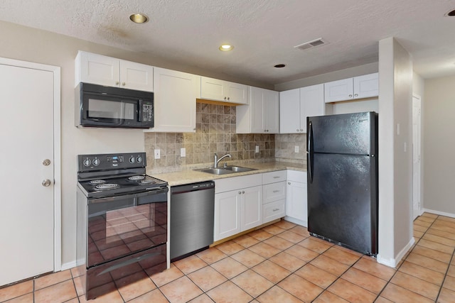 kitchen featuring white cabinetry, black appliances, sink, and light tile patterned floors