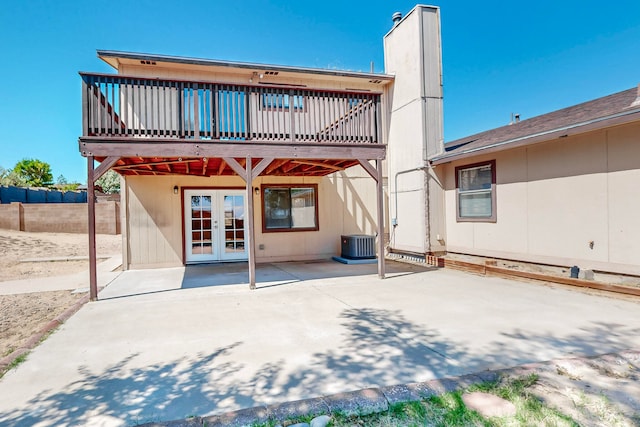 rear view of property with central AC unit, a patio, french doors, and a deck