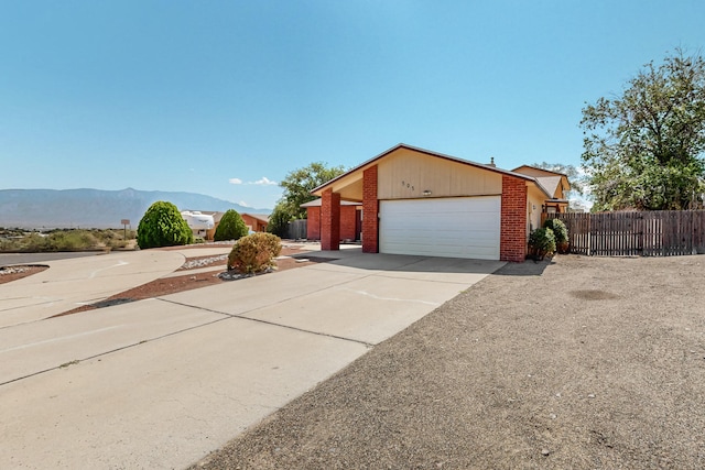 view of side of home featuring a garage and a mountain view