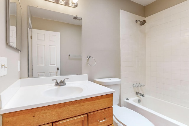 full bathroom featuring vanity, toilet, and tiled shower / bath combo