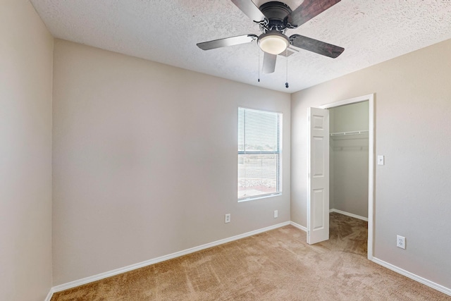 unfurnished bedroom with a textured ceiling, light carpet, ceiling fan, and a closet