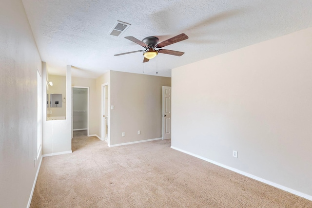 carpeted empty room with electric panel, ceiling fan, and a textured ceiling