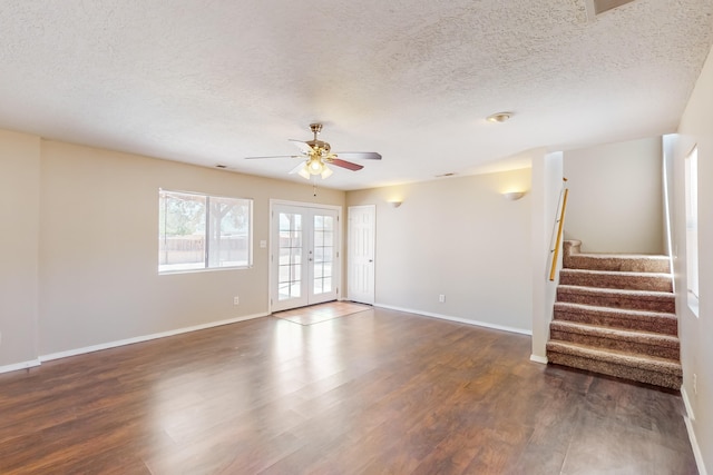 unfurnished room featuring a textured ceiling, french doors, dark hardwood / wood-style floors, and ceiling fan