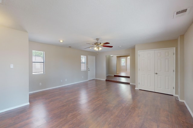 spare room featuring ceiling fan and dark hardwood / wood-style floors