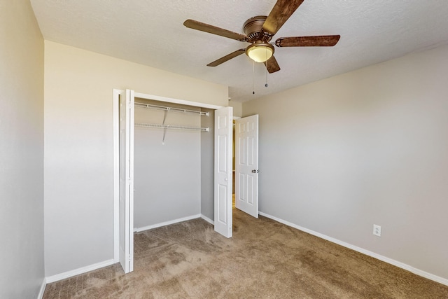 unfurnished bedroom featuring a textured ceiling, light carpet, ceiling fan, and a closet