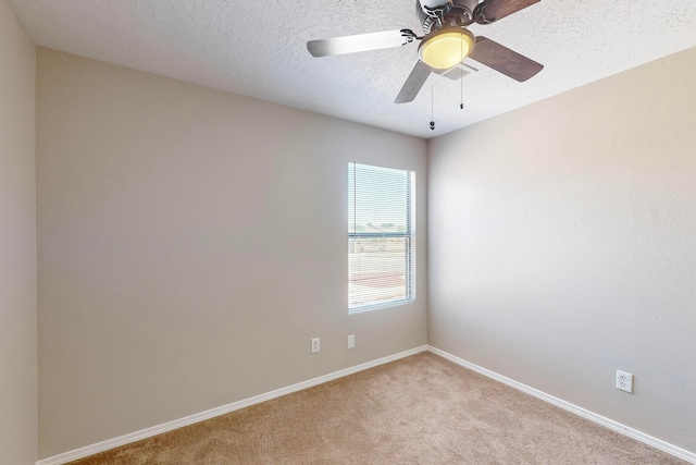 carpeted spare room featuring a textured ceiling and ceiling fan