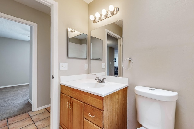 bathroom with vanity, tile patterned floors, and toilet